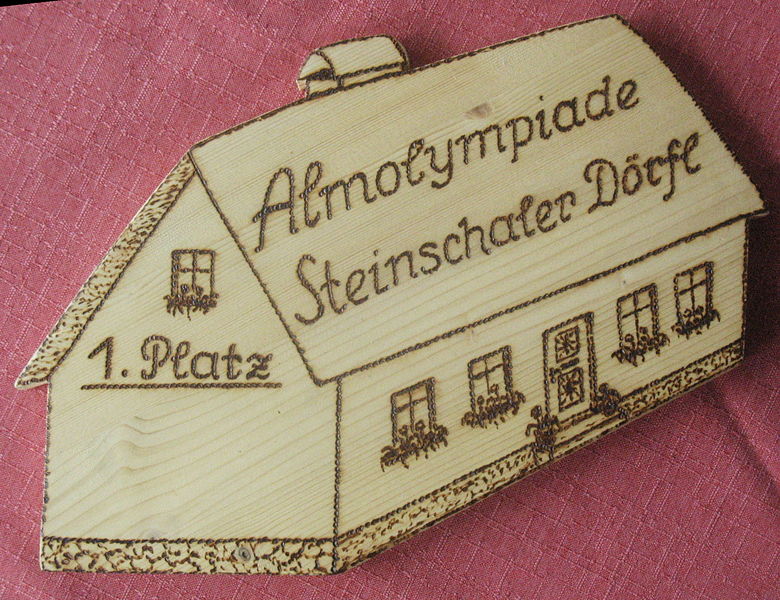 Datei:Almolympiade Holzschild.jpg